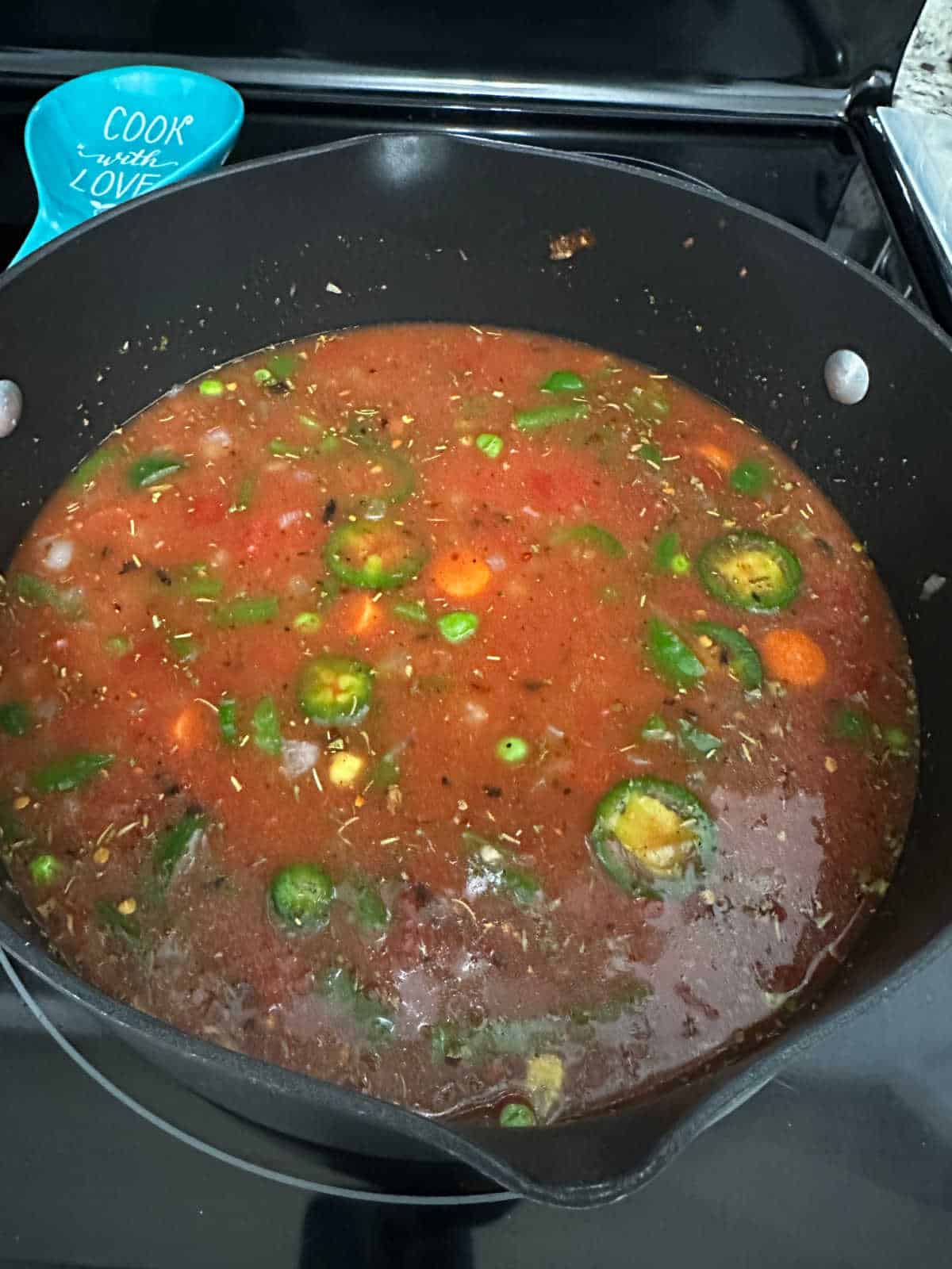 Process shot - overhead image of large pot full of soup. 