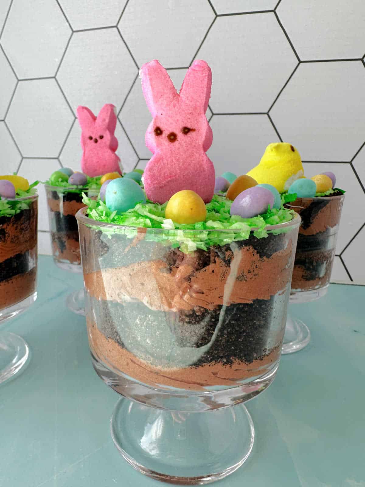 Close up image of individual dirt cake topped with a bunny. 