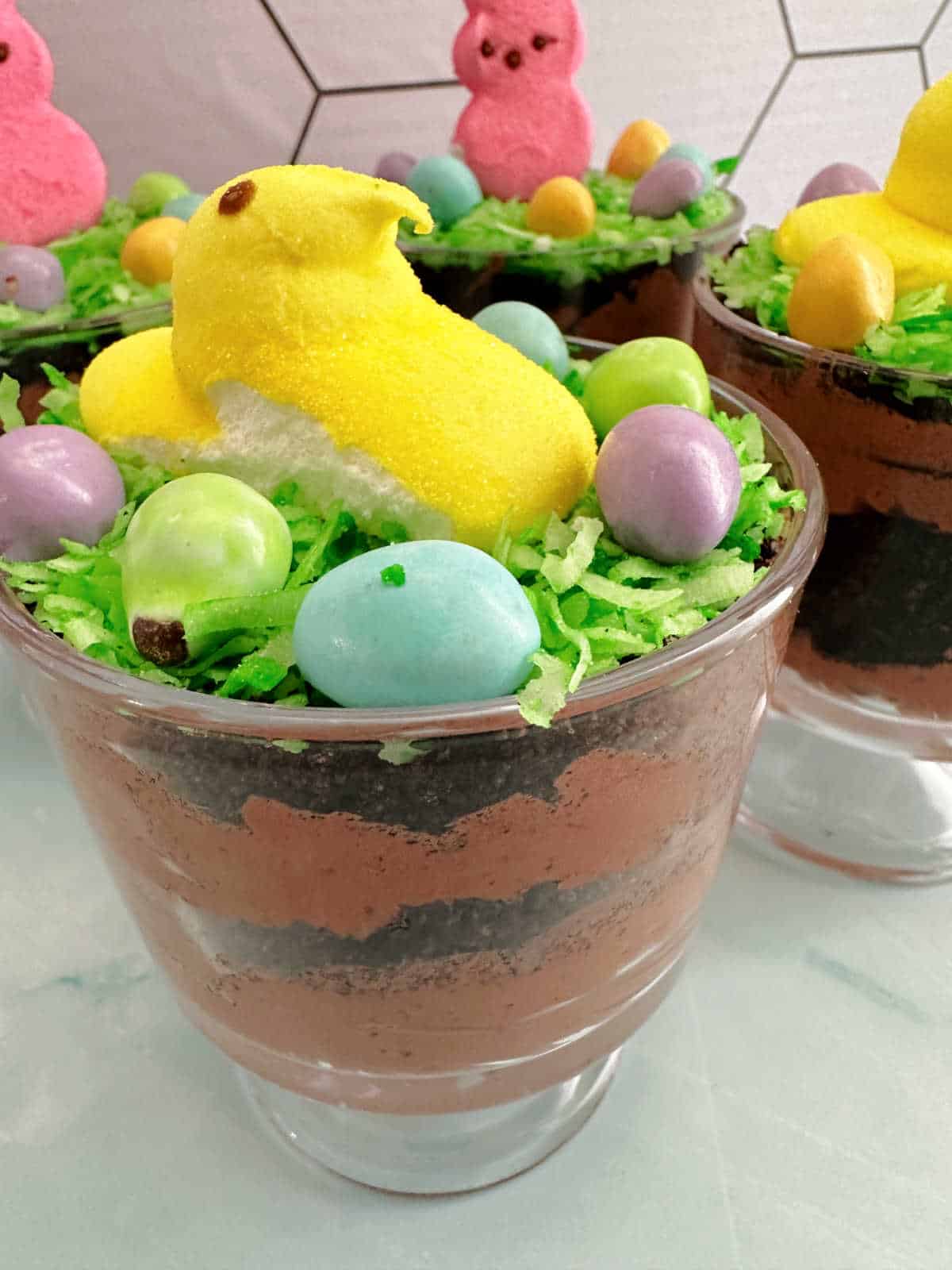 Close up of Peeps chick topped dirt cake in a mini trifle bowl. 