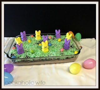 9x13 baking dish of completed dish, bunnies standing on coconut grass with candy eggs around them. 