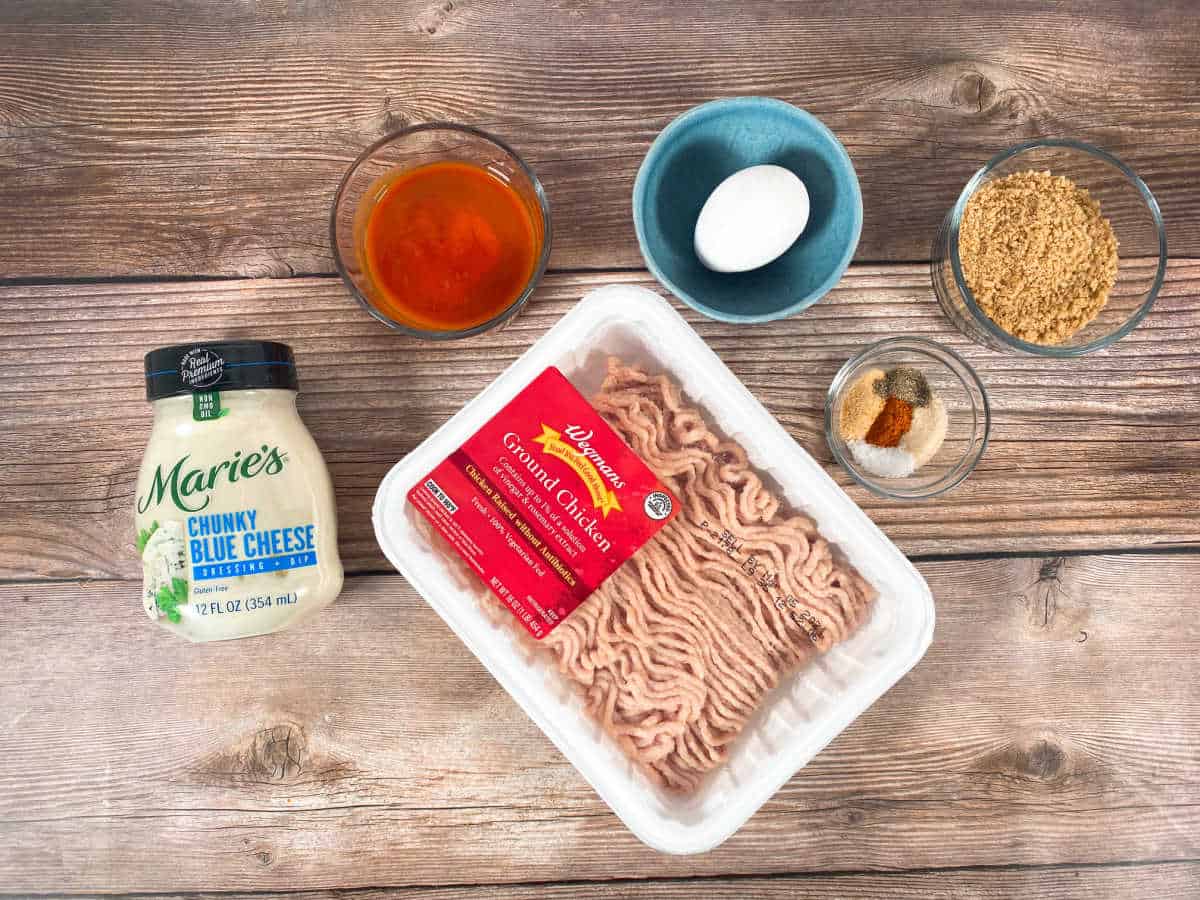 Ingredients for the recipe sit on a wooden background. 