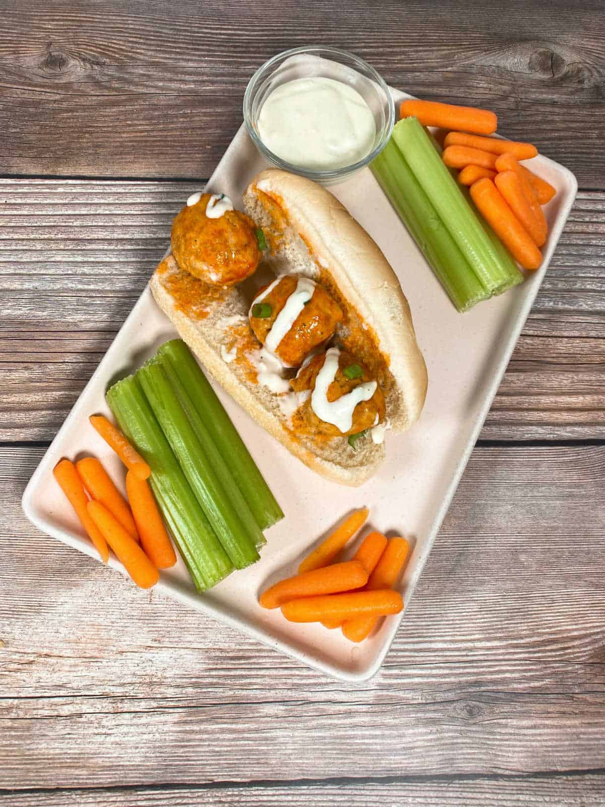 Meatballs, served on a sub roll, drizzled with blue cheese and surrounded by carrots, celery sticks and blue cheese dressing. 