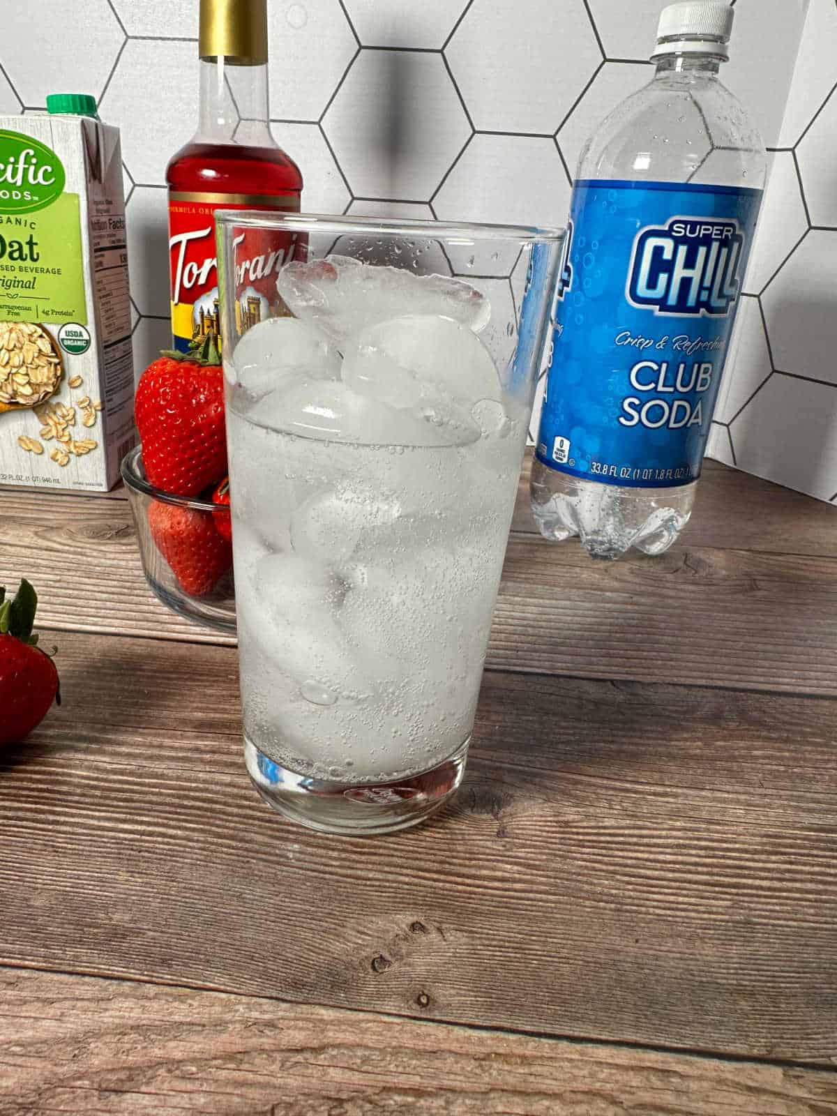 Club soda poured into a glass with ice. 