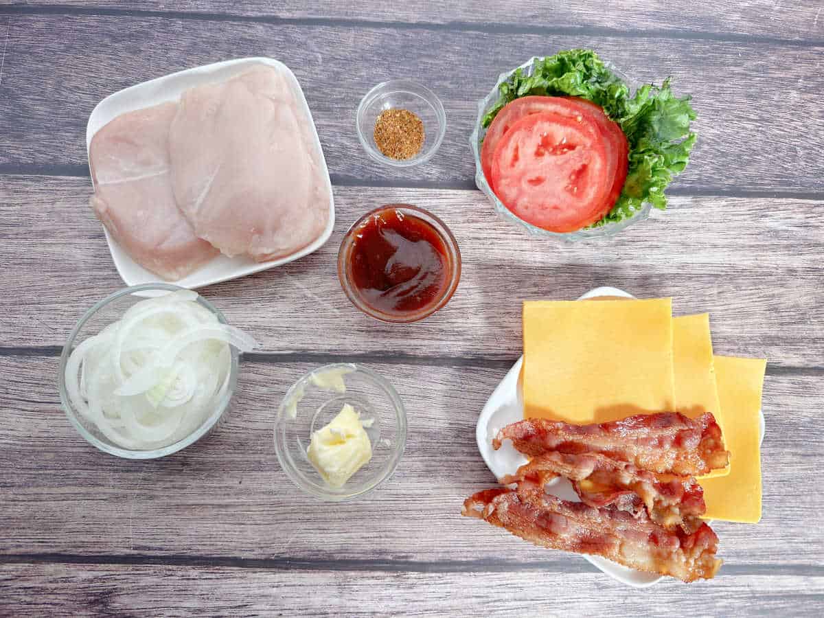 ingredients for sandwich sit on a wooden background. 