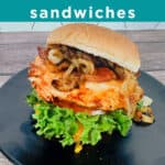 Image for Pinterest, white text overlay on teal background. Cowgirl Chicken Sandwich is a BBQ chicken cutlet with lettuce, tomato, bacon, caramelized onions and cheddar cheese on a burger bun.