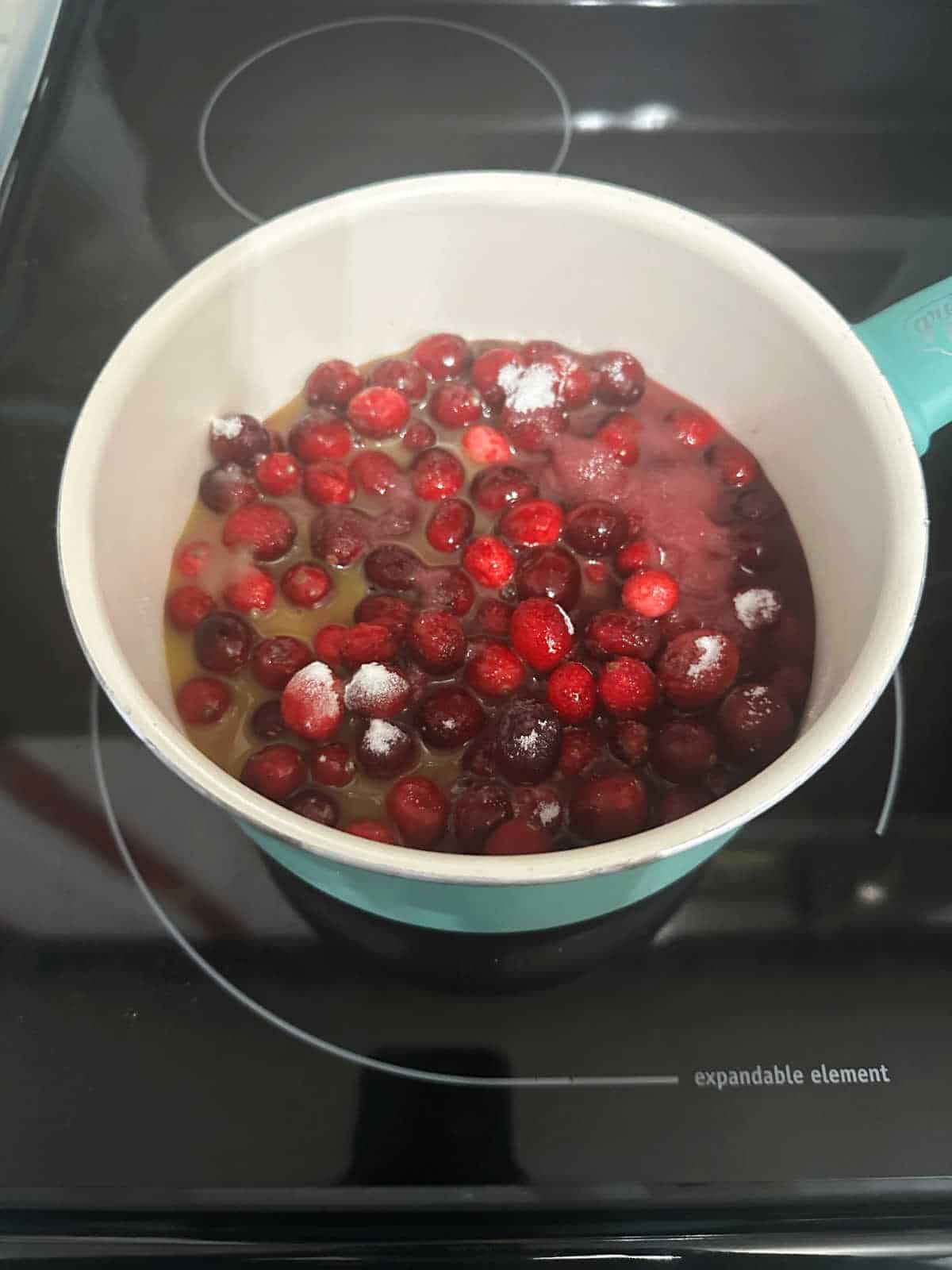 Cranberry sauce cooking on the stove.