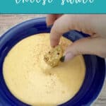 Image for Pinterest: cheese sauce in a blue bowl with a soft pretzel being dipped in. Text overlay of recipe name.
