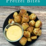 Image for Pinterest with text overlay. Plate of piled high soft pretzels with a small bowl of cheese sauce on the side.