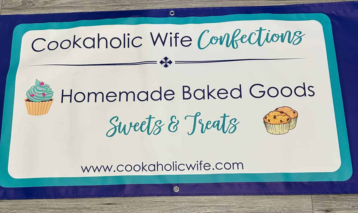banner used at events, wording in navy blue and teal on a white background. Images of cupcake and muffins.