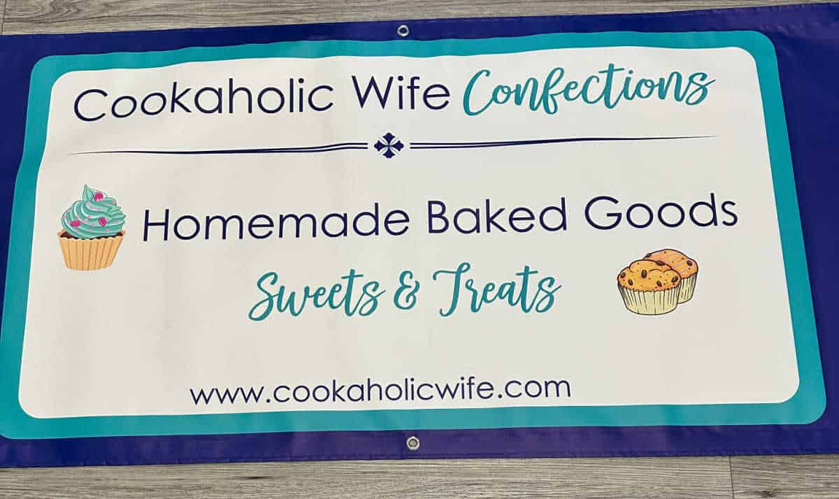 banner used at events, wording in navy blue and teal on a white background. Images of cupcake and muffins. 